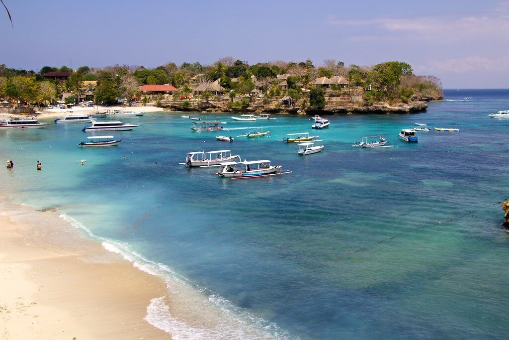 Boats moored off the beach — how nearly everything moves around the island.