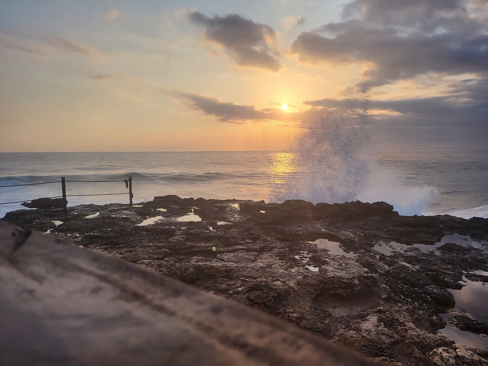 Sunset over the Devil's Tear shoreline, spray still lifting off the rocks.