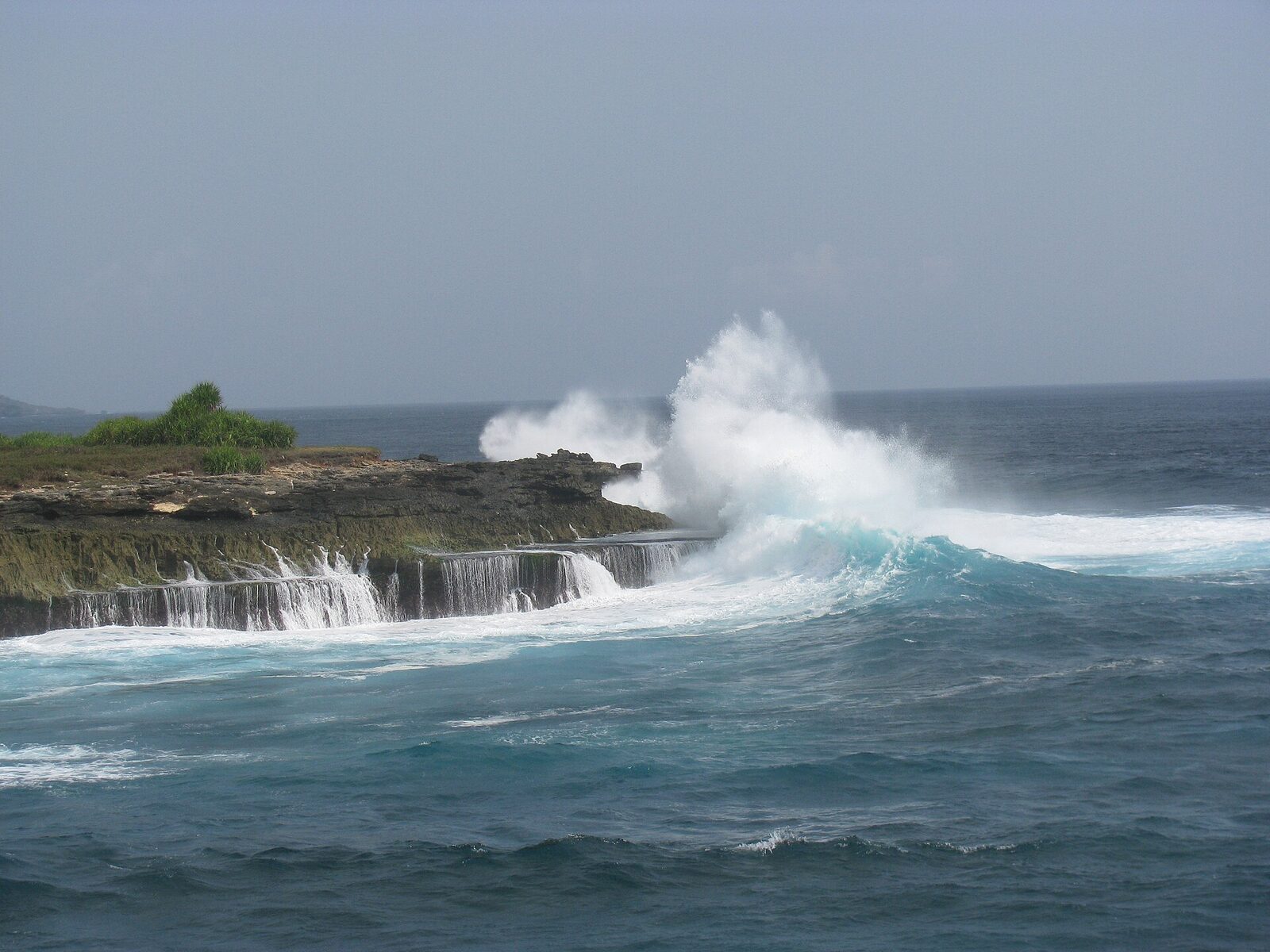 Devil's Tear: a swell detonating into spray on the rock shelf — the show, and the trap.