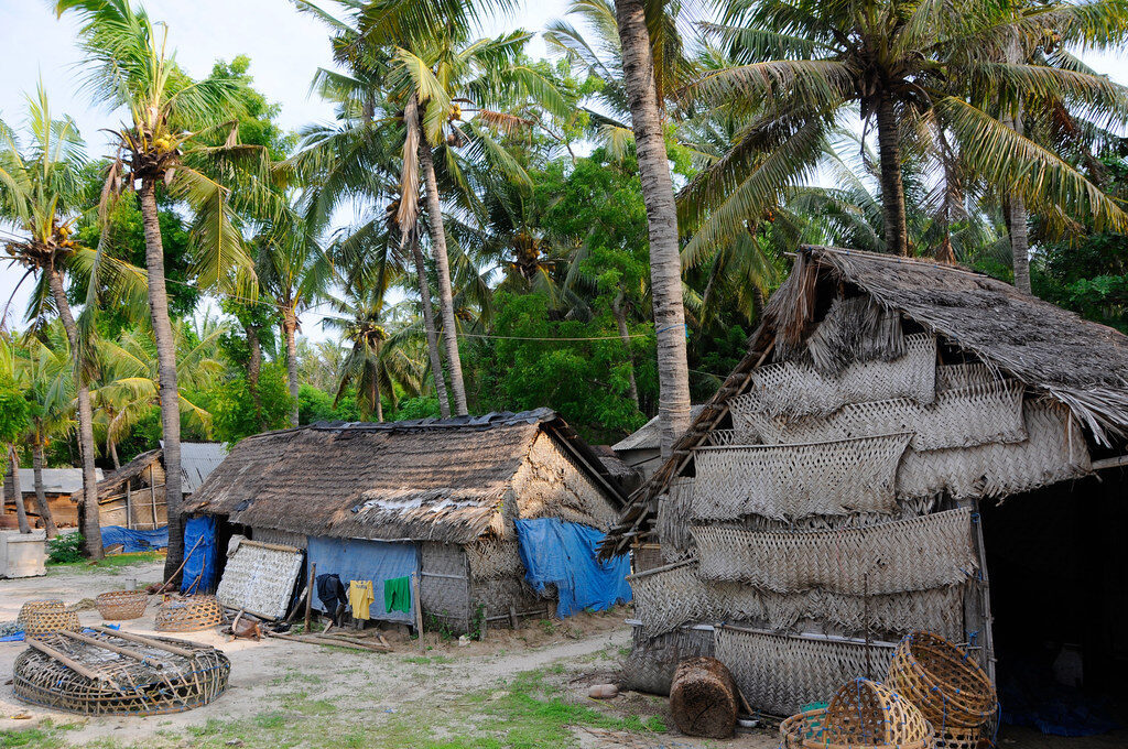 Thatched fishermen's huts and drying gear — the working-island side the glossier spots have lost.