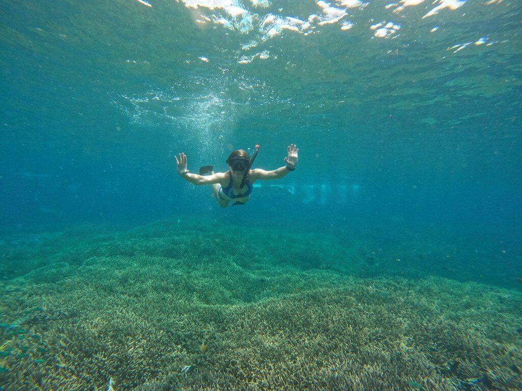 A snorkeller over the reef shallows off Lembongan — go with a boat and a vest; the current is no joke.