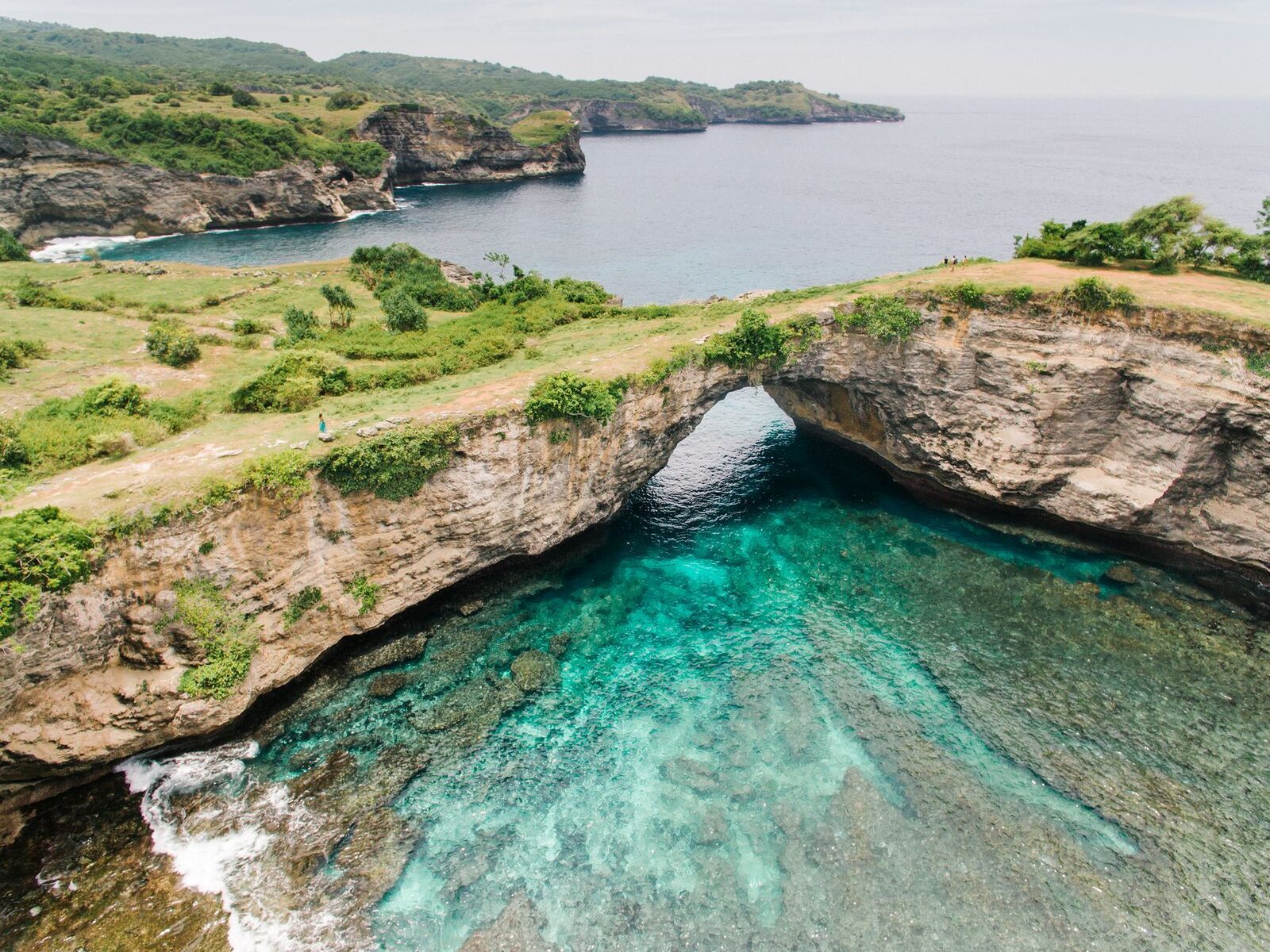 Ceningan's Blue Lagoon, the electric-blue inlet below the cliffs.