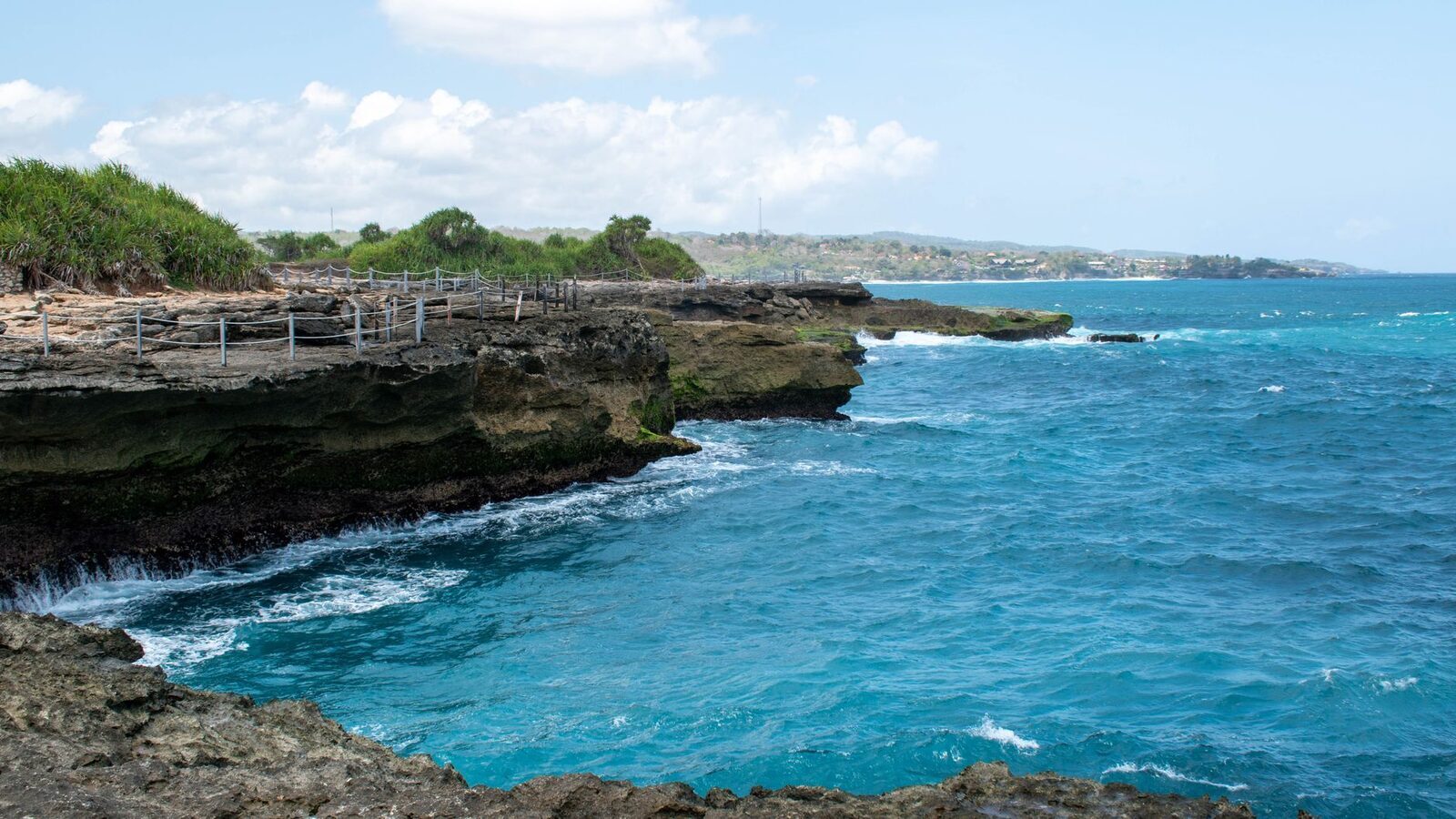 Ceningan's rocky, cliff-lined coast on the far side of the bridge.