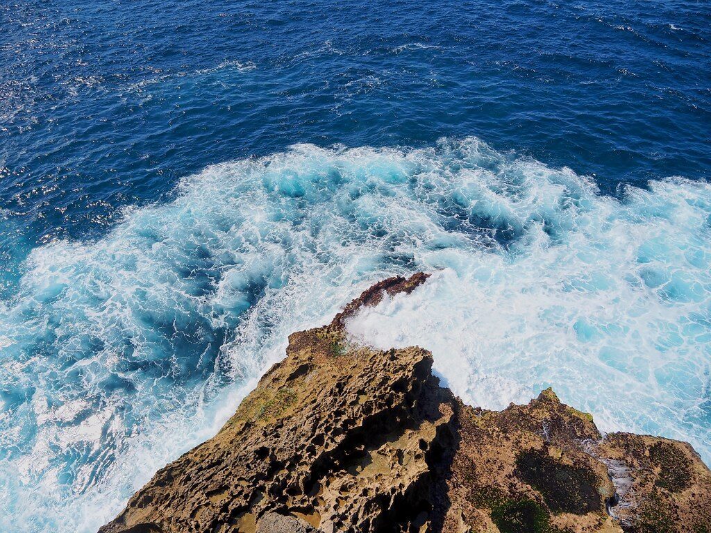 The open sea surging against the rocks beside the pool — this is how rogue waves sweep people off.