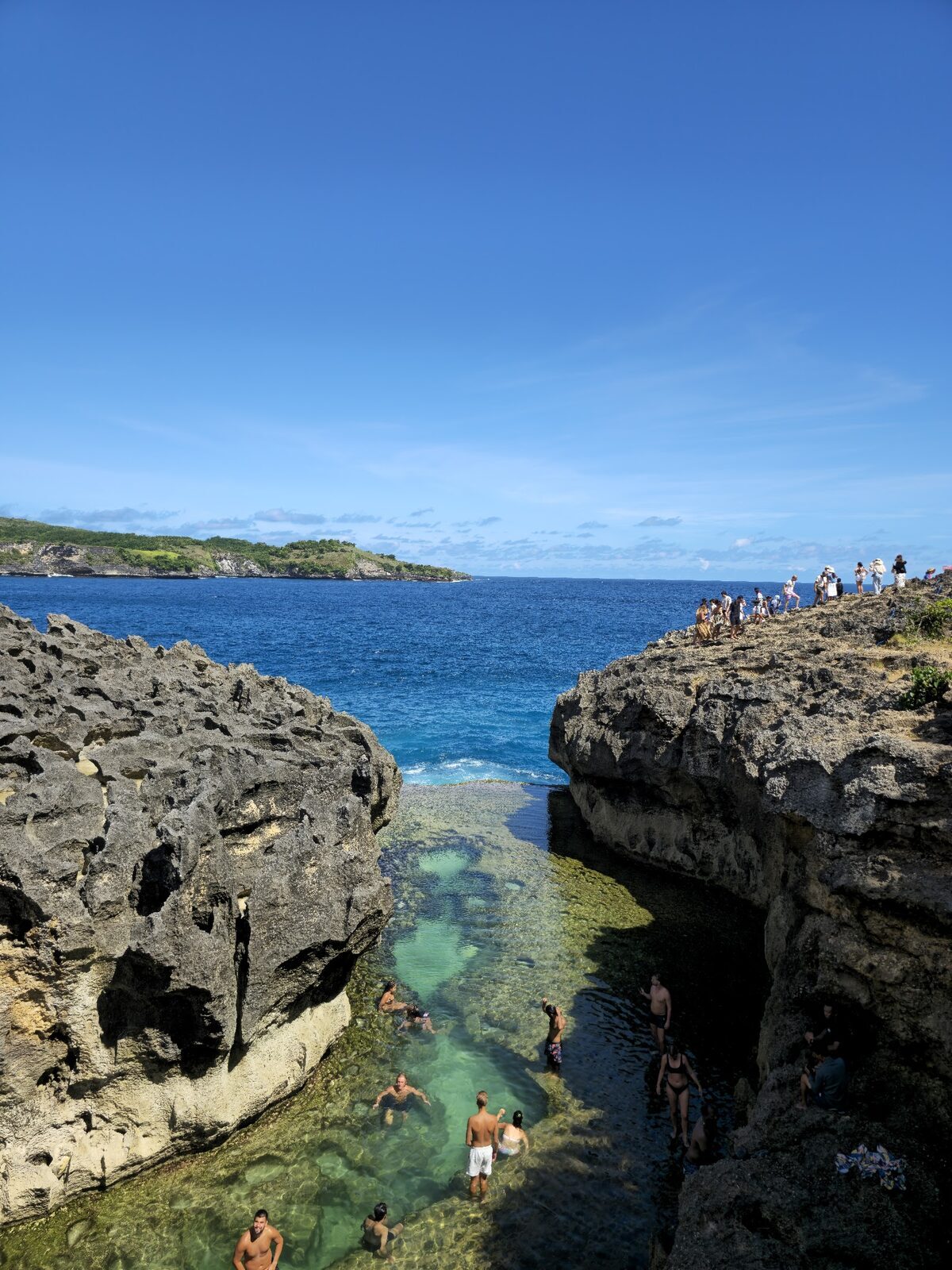 People swimming in the natural rock pool.