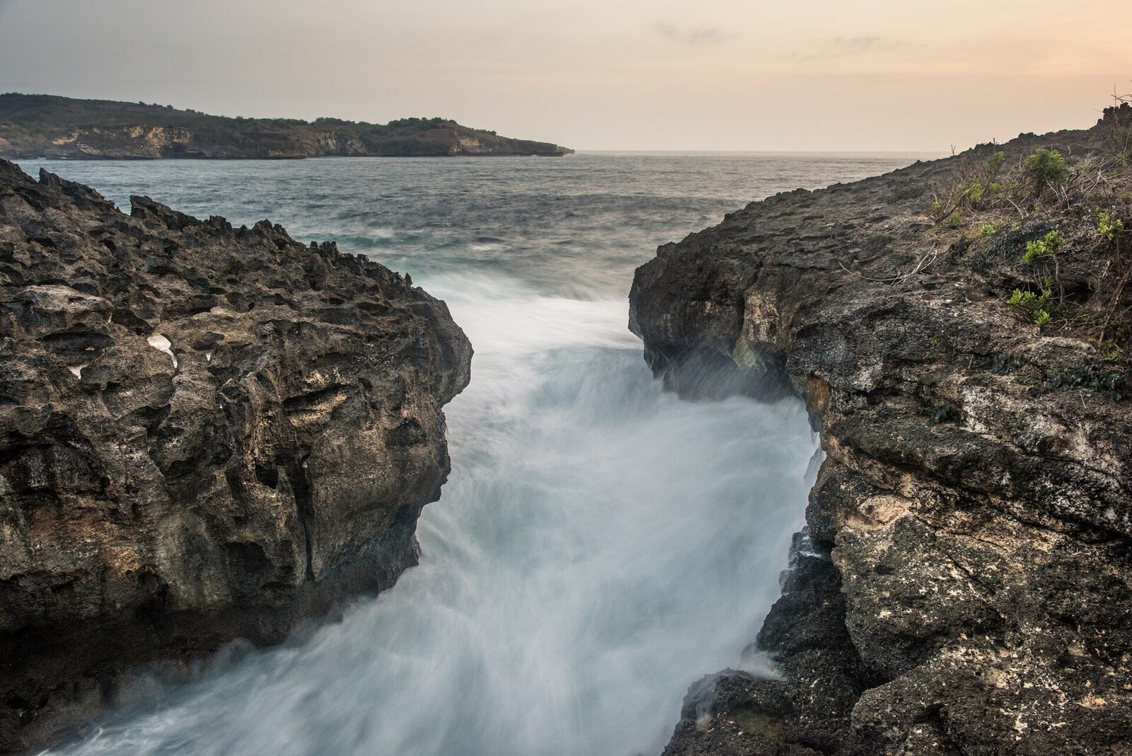 The Billabong channel at dusk, the sea funnelling in between the rock walls.