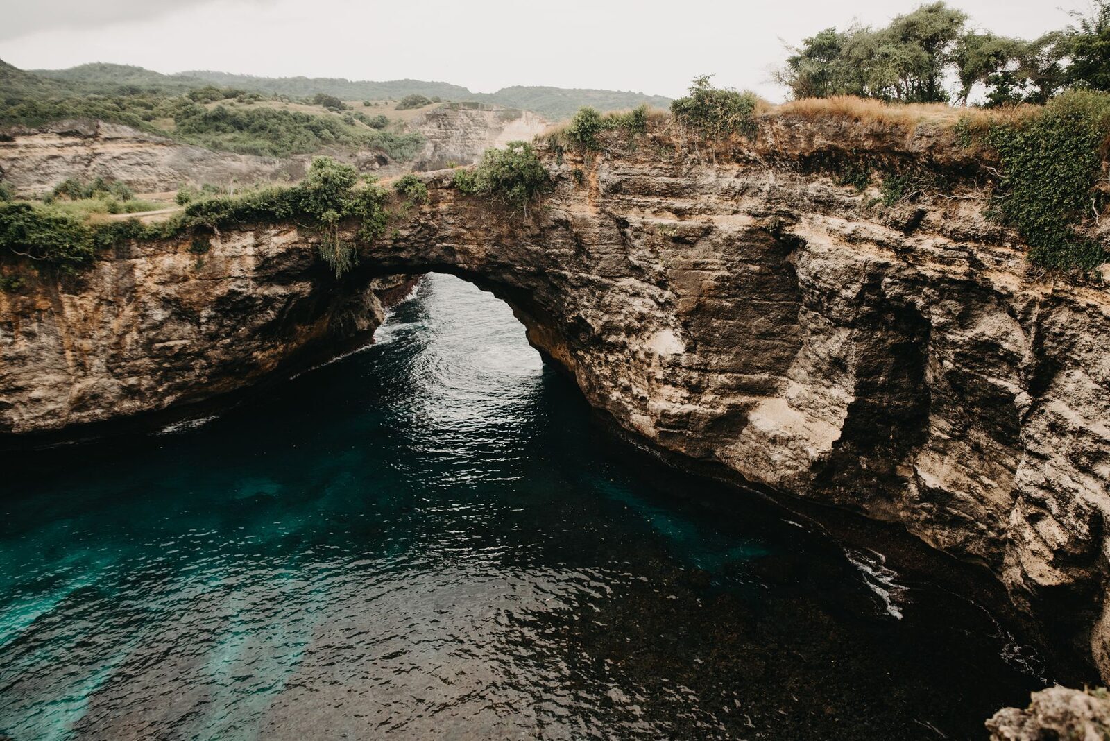 The Broken Beach arch and its enclosed lagoon, wide view.