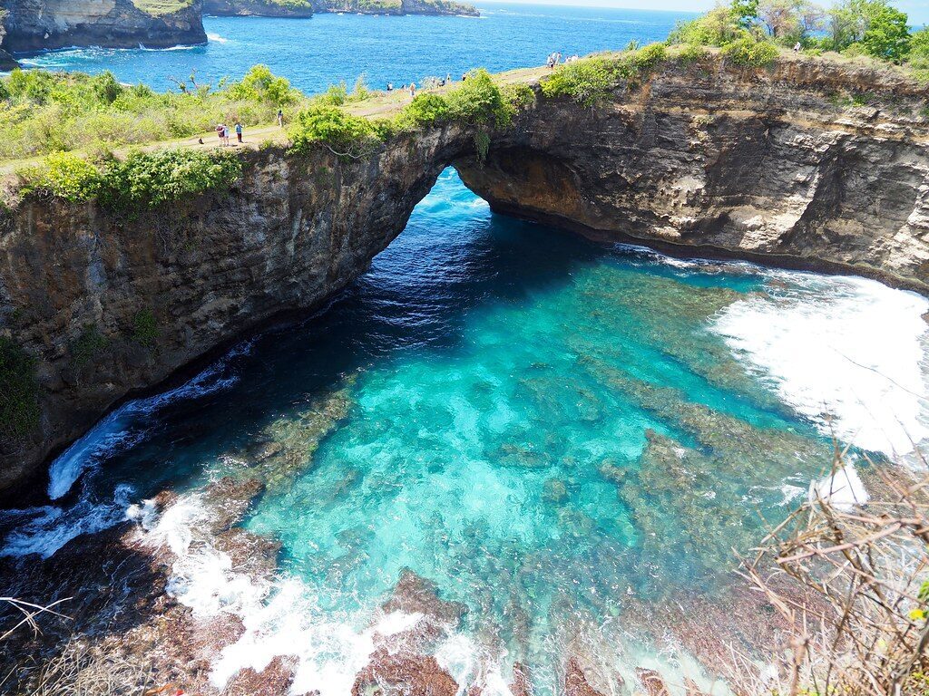 An aerial angle on the arch and the reef in the lagoon below.