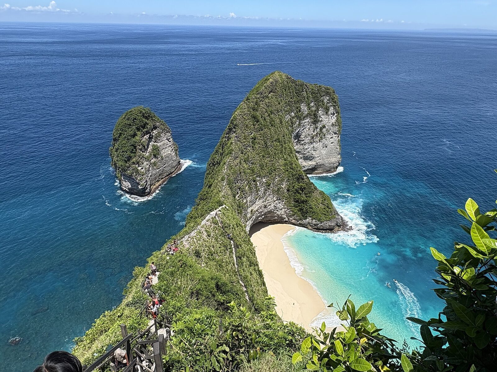 The Kelingking headland — the T-rex-shaped cliff with its thread of white-sand beach far below.