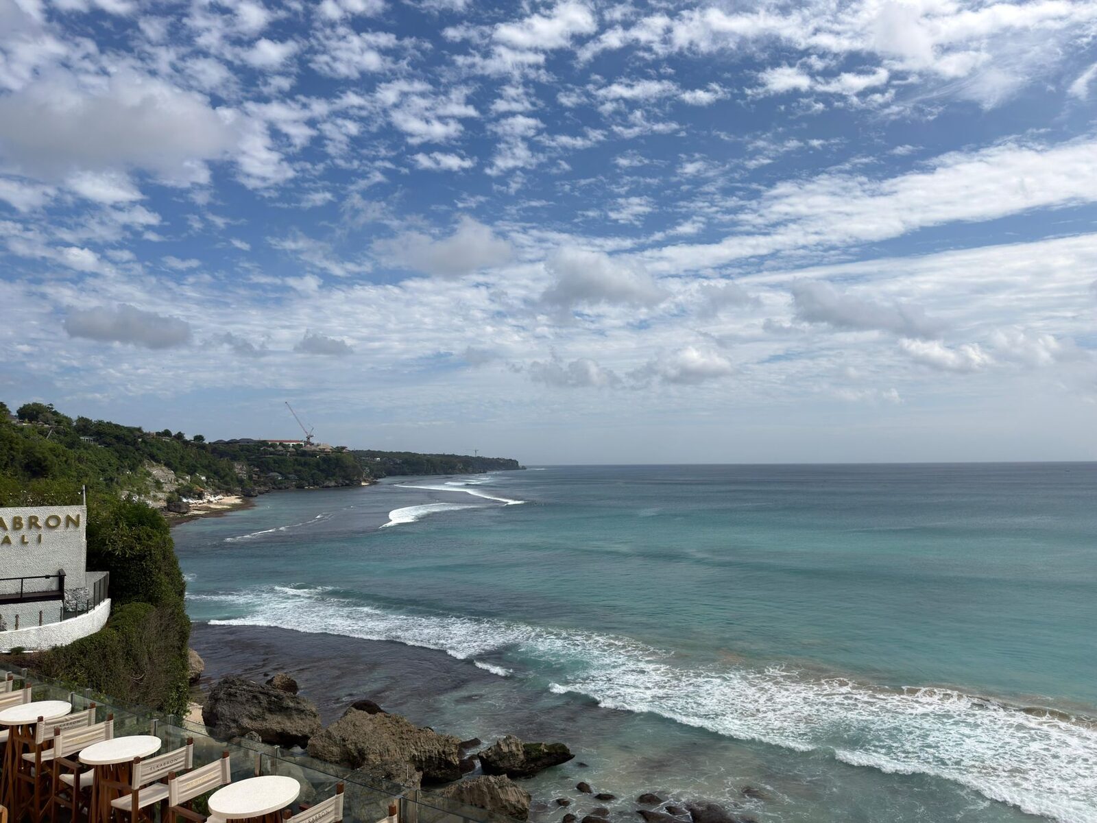 A cliff-edge cafe deck perched over the rocky shore.