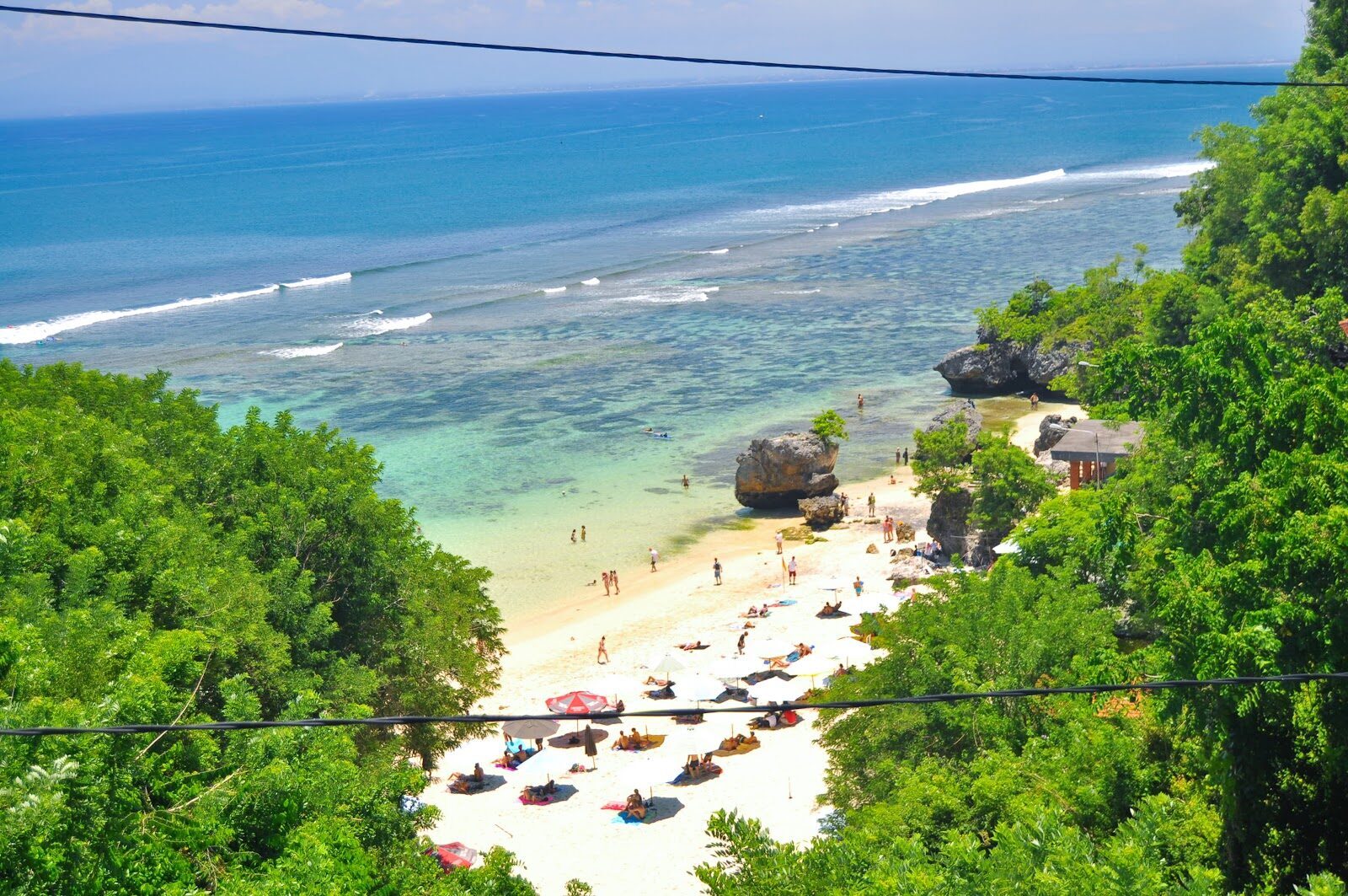 Looking down onto Padang Padang's tiny beach and its umbrellas from the cliff above.