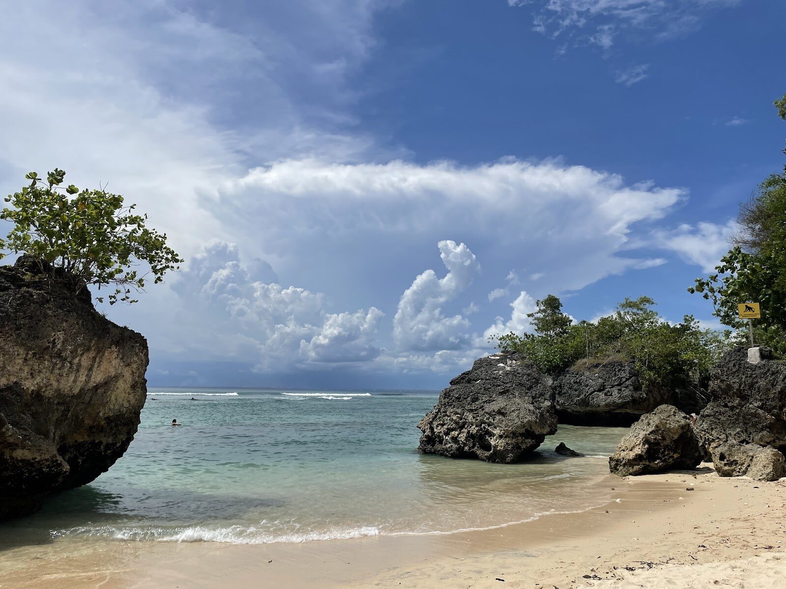 A small cove framed by tall rocks on the Bukit coast.
