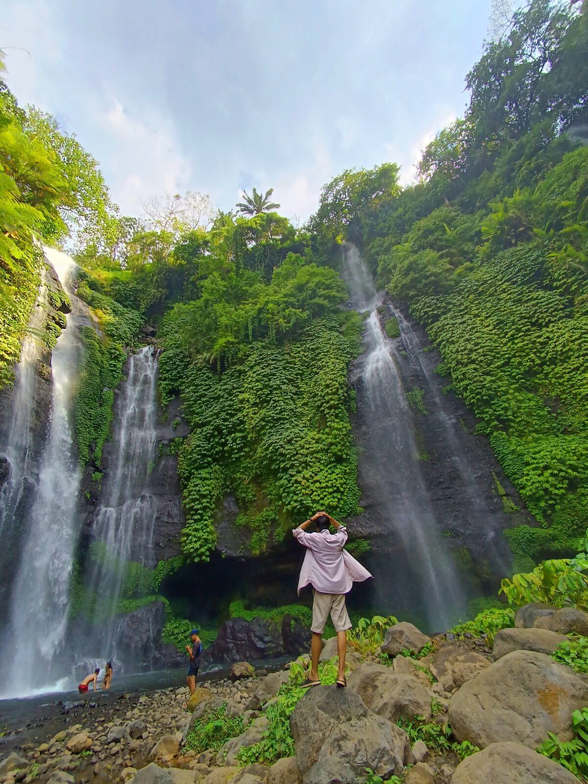 Twin falls with visitors below for scale — a second stop for those with the legs for it.