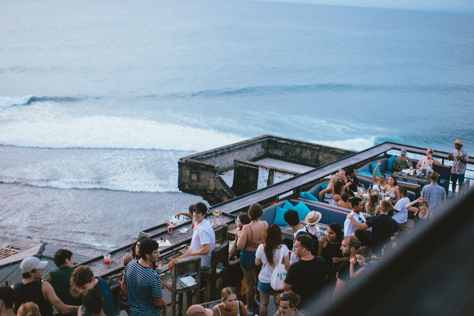 A clifftop beach bar at sunset — the mainstream nightlife, where a good night can quietly turn on a spiked or methanol-laced drink.