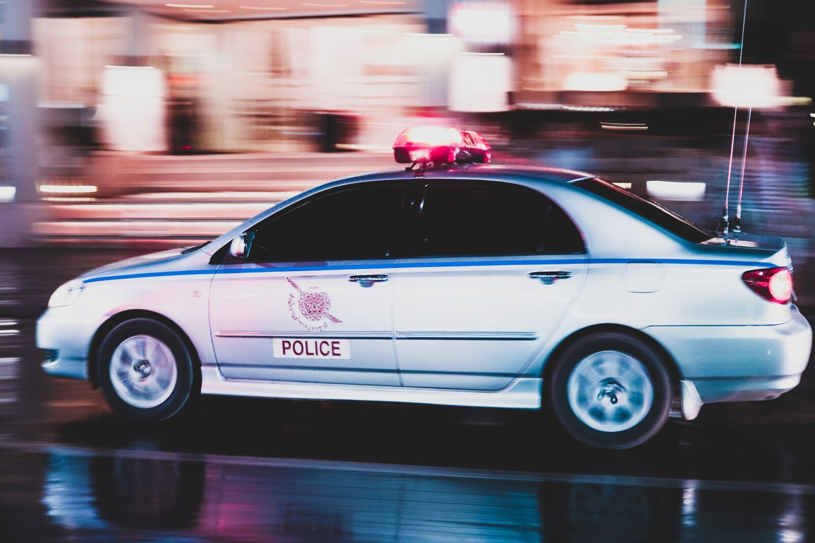 An Indonesian police car — enforcement is patchy but real, and it mostly moves the trade around rather than ending it.