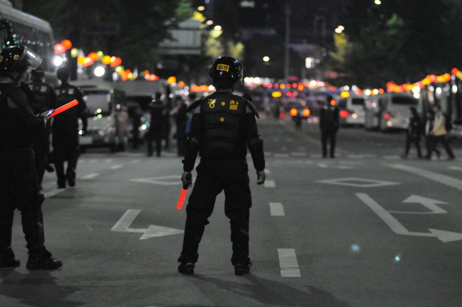 An Indonesian police operation working a night street — raids and stings on the sex trade happen, and getting caught even at the edges means detention and a ruined trip.