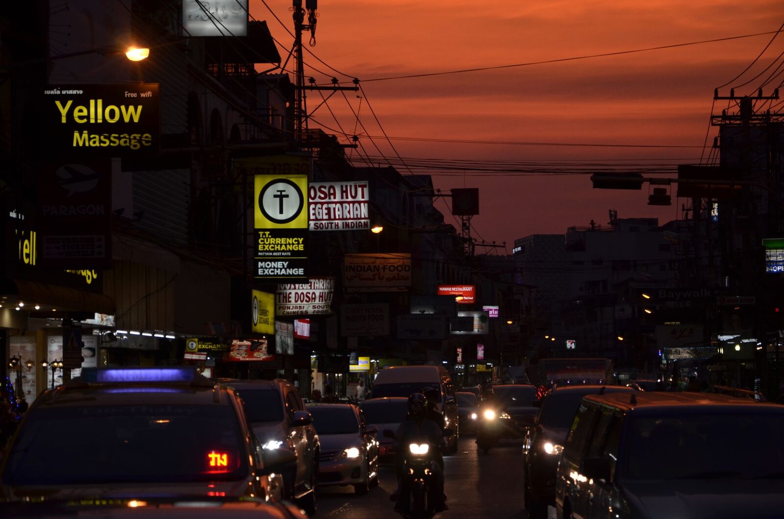 A 'massage' sign glowing at dusk.