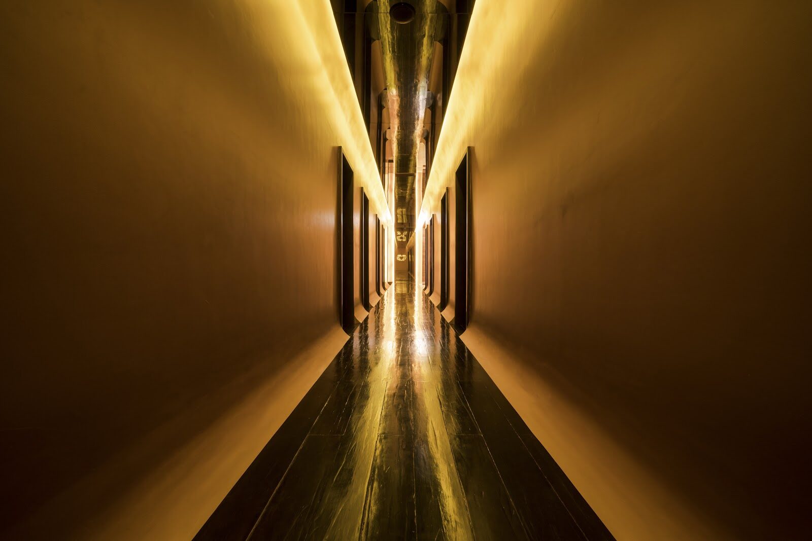 A dim, unmarked corridor — the opposite of a real spa with posted prices and a proper reception.