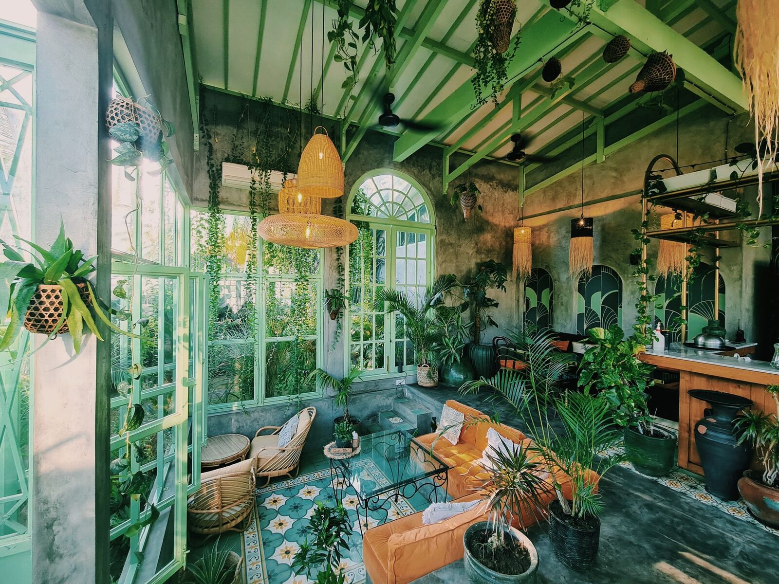 A Canggu café mid-morning — the kind of easy, plant-filled room where a solo traveller lands, orders a coffee, and has a new friend by lunchtime.