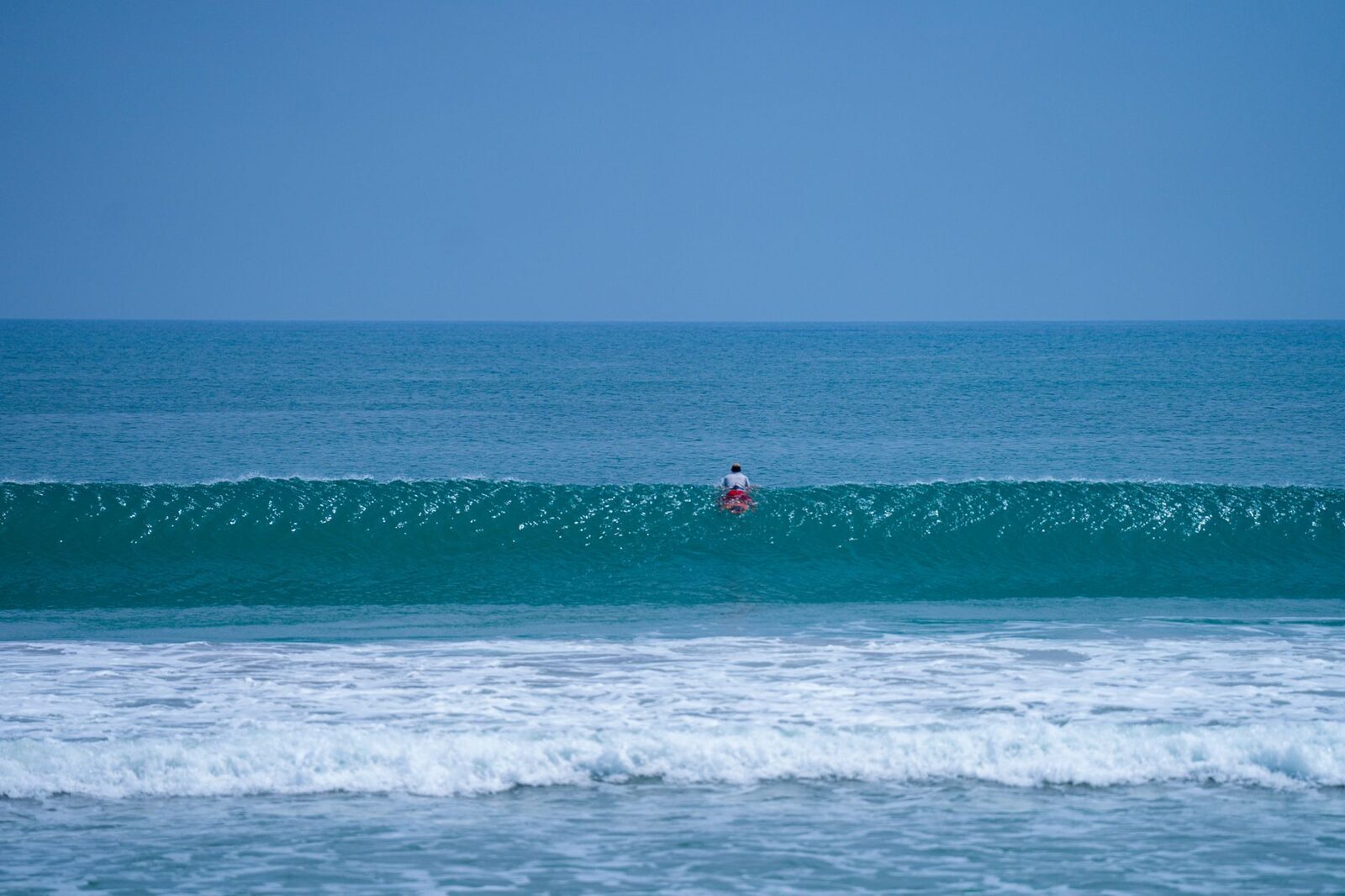 A clean, gentle wave rolling in over sand, the friendly end of Bali surf.