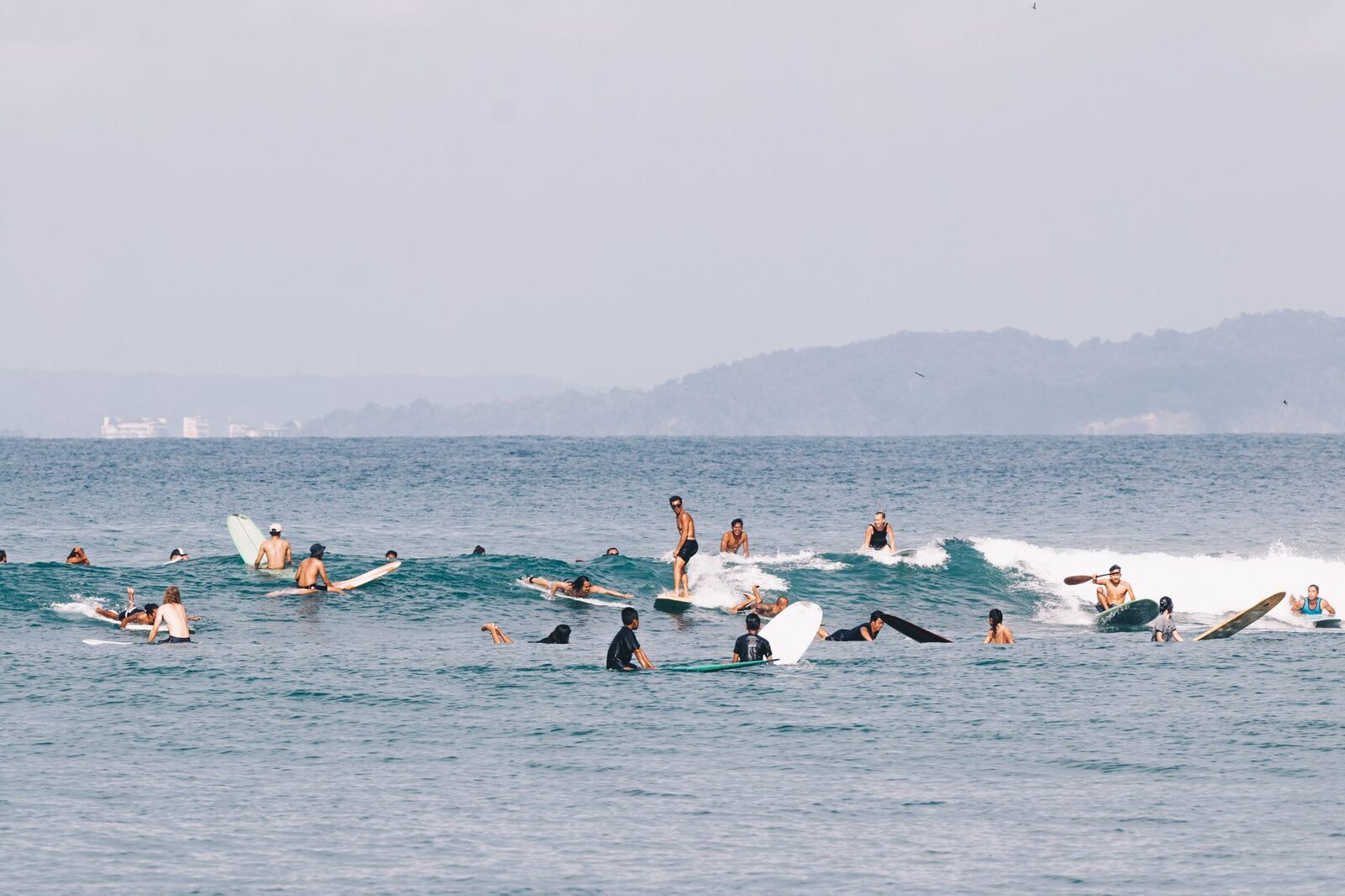 A group session in the shallows — surf camps and lessons are the easiest way to actually progress.