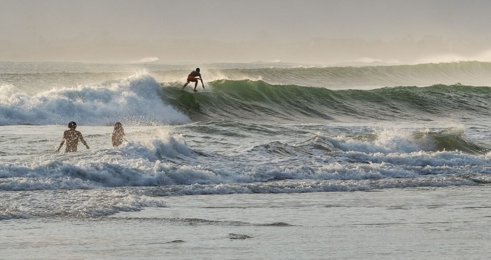 A soft, unwinding point wave with surfers in the water, less crowded and more soul than the beach breaks.