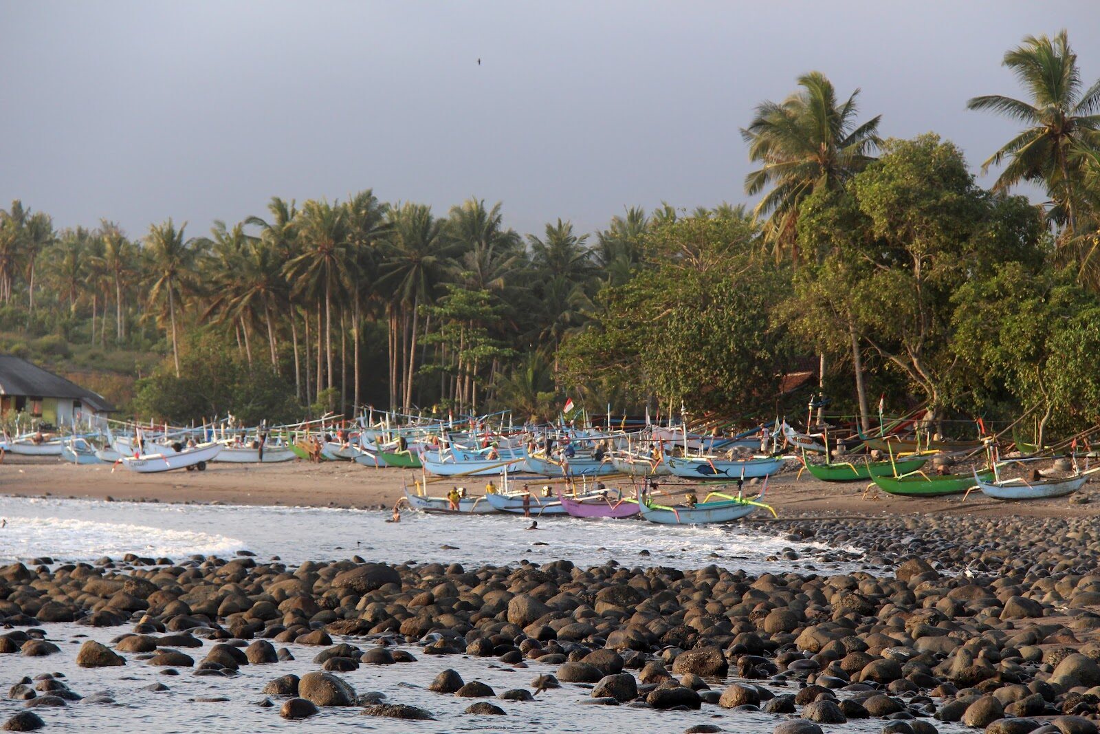 A rocky, palm-backed river-mouth beach on the west coast — great long lefts, but a rocky entry, so bring booties.