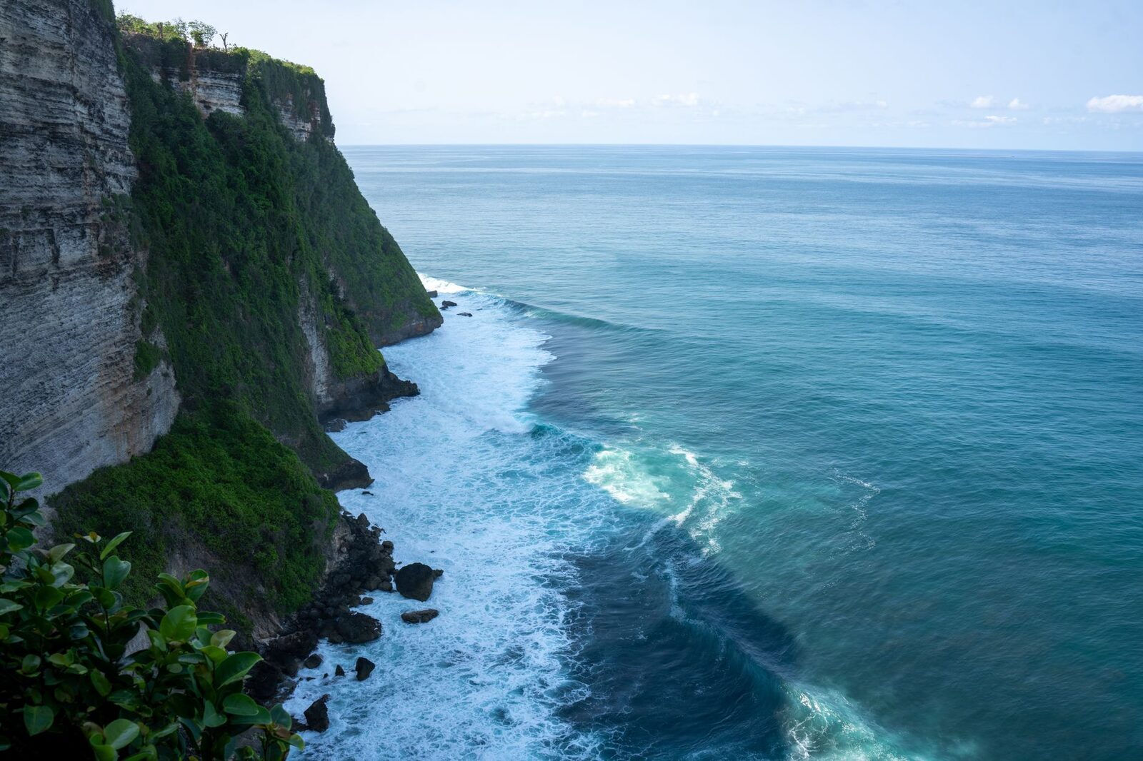 The sheer Uluwatu sea-cliffs — the cave-and-stairs access down to the water is no joke.