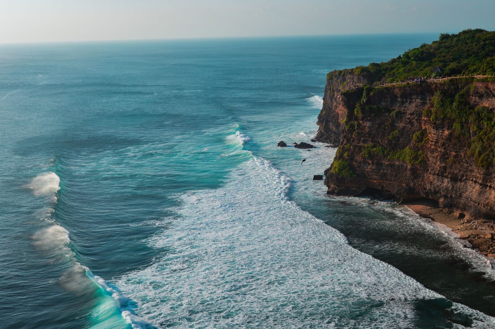 The Uluwatu cliff with the reef point wrapping below — the Bukit catches the Indian Ocean swell full-on, and the reefs here are world-class.