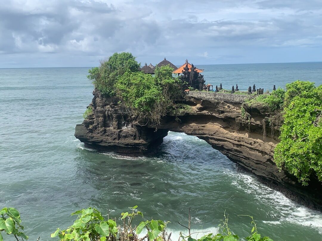 The rock arch of Batu Bolong from the cliff path.