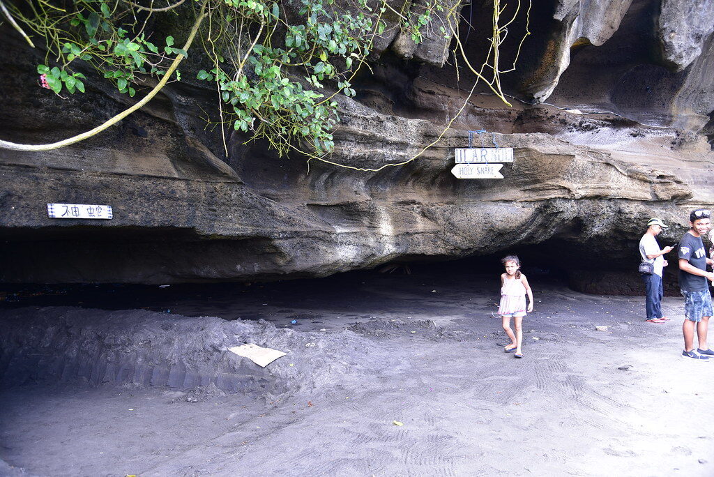Inside one of the sea caves at the foot of the rock, reachable only at low tide.