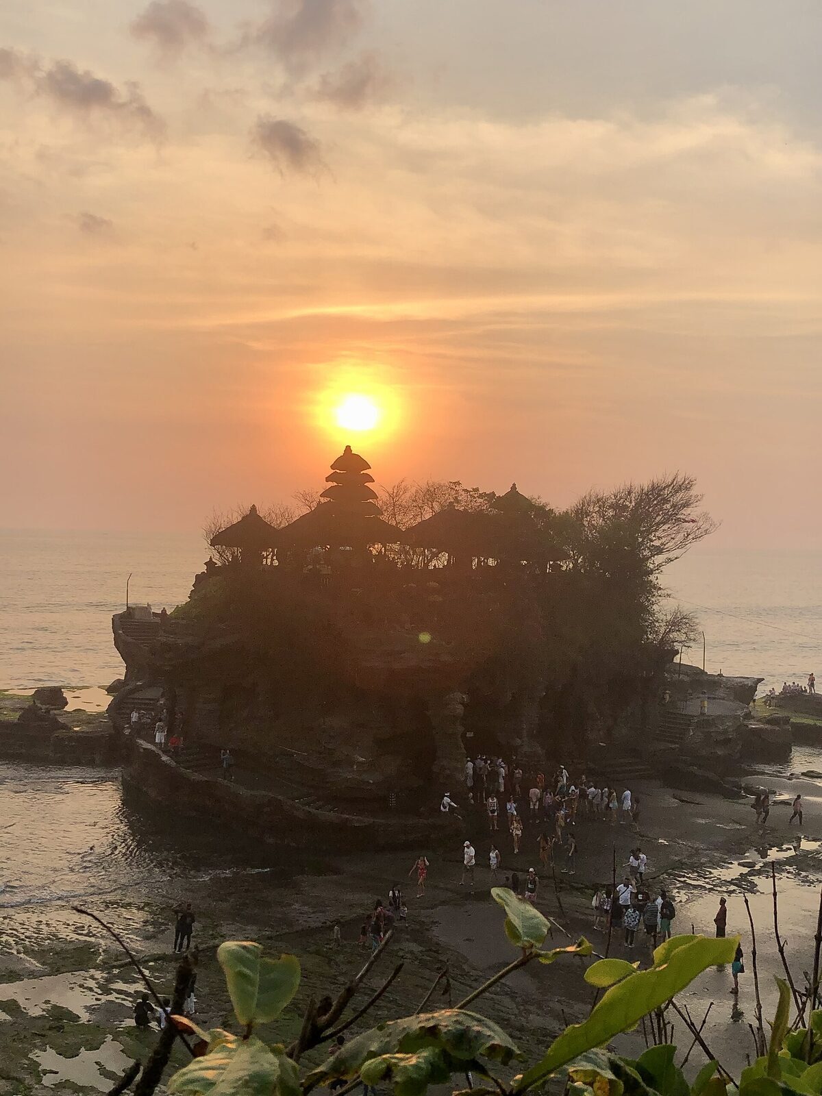 The sun sinking directly behind the temple rock.