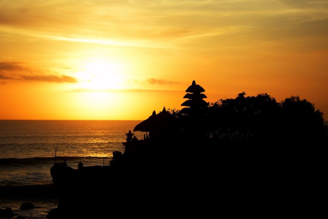 Sunset: the temple goes black against the sky as the sun drops behind it — the shot that draws the crowd.
