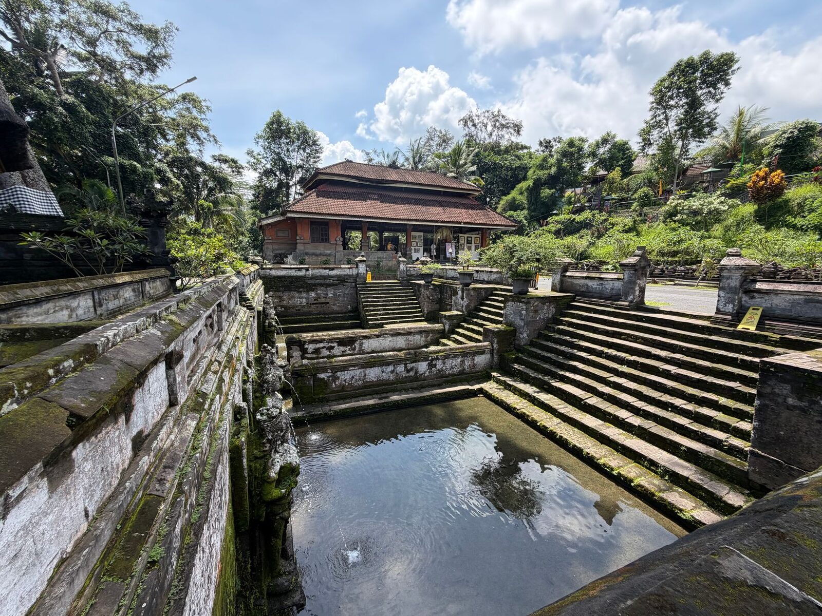 A quieter corner of the complex, stone steps down to a green pool.