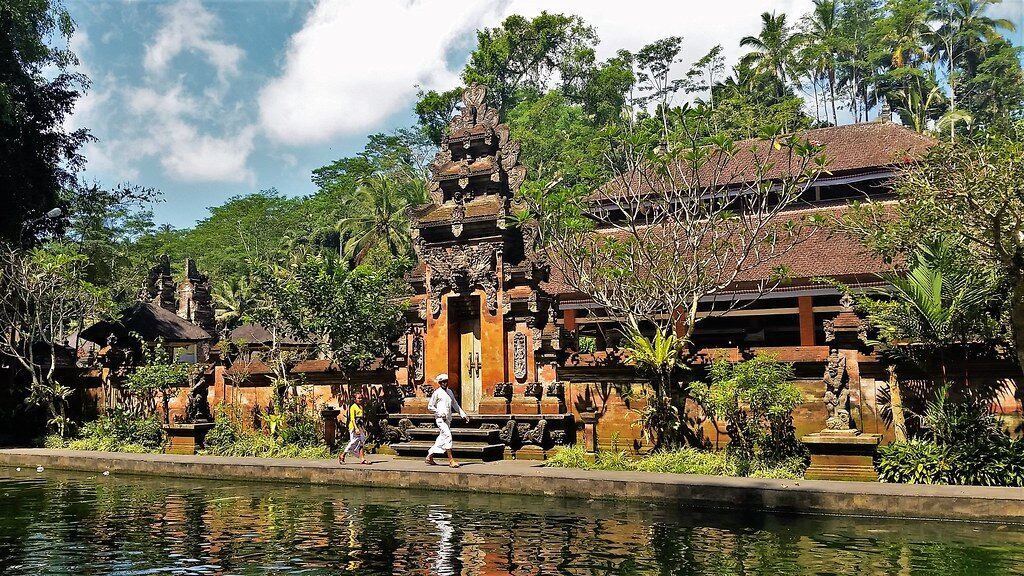 What Tirta Empul actually looks like: a working temple compound of grey stone, ponds and pavilions set in the trees.