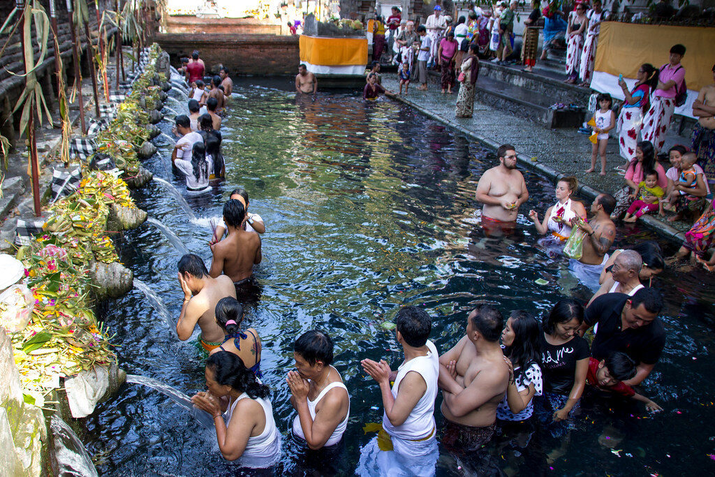 The pools packed shoulder to shoulder — the reality most of the day, not the empty-pool photo you saw online.