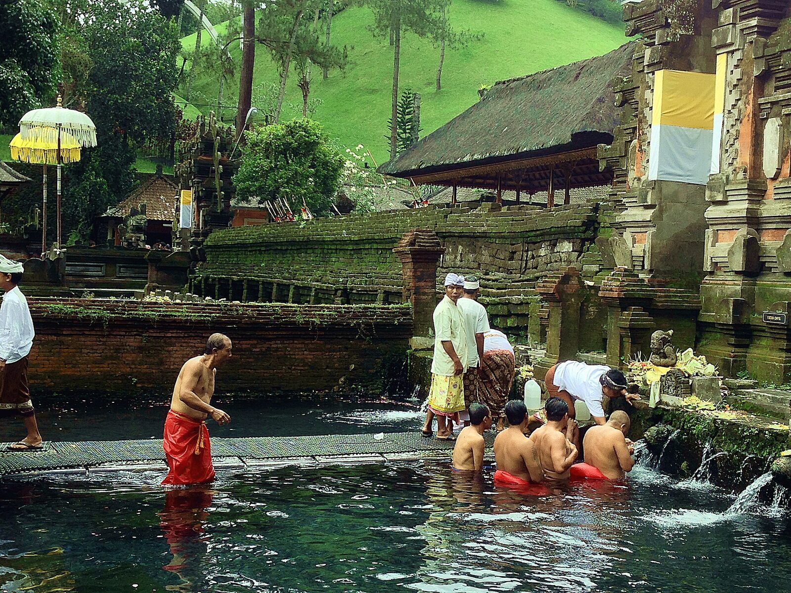 The source itself — water welling up in a clear tank, the reason a temple has stood here for a thousand years.