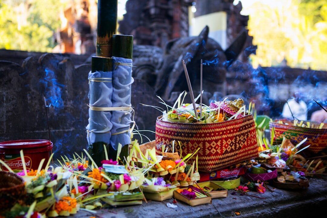 Canang sari offerings set out on a temple ledge — the daily currency of Balinese devotion.