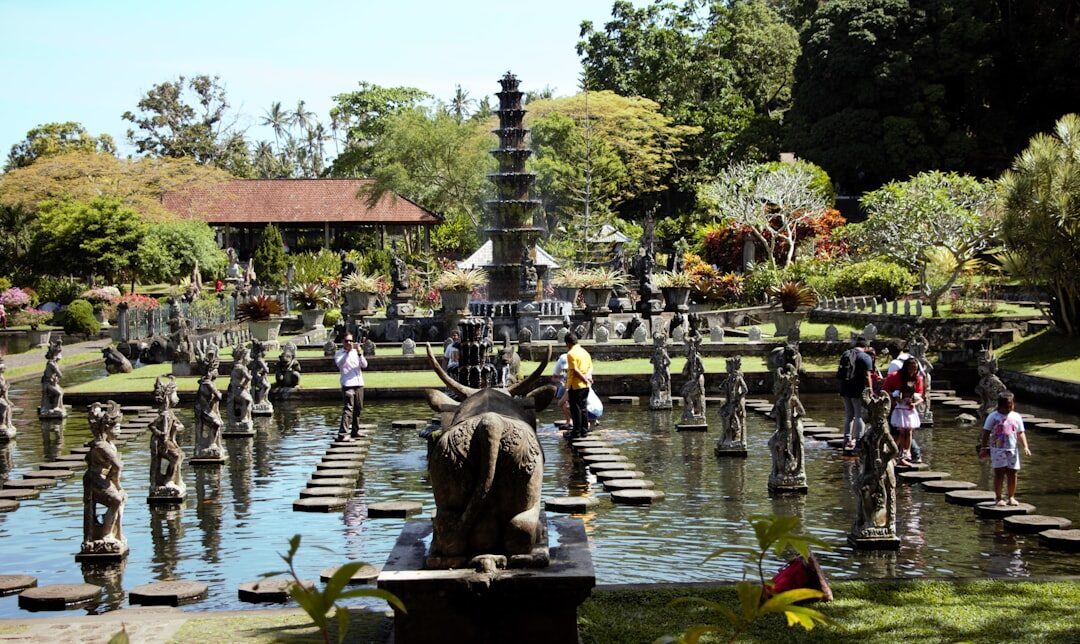 Visitors working their way around the pond and its statues.