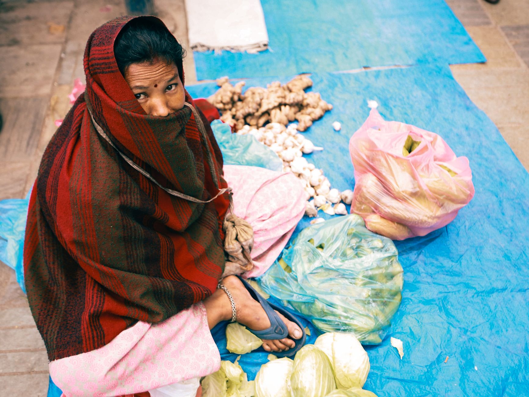 A woman selling vegetables at a Bali market