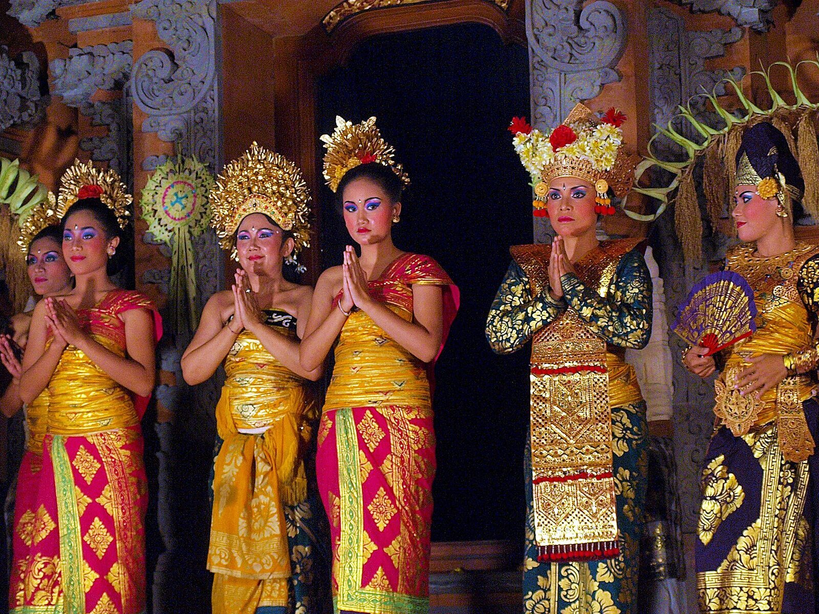 A row of costumed dancers on the courtyard stage.