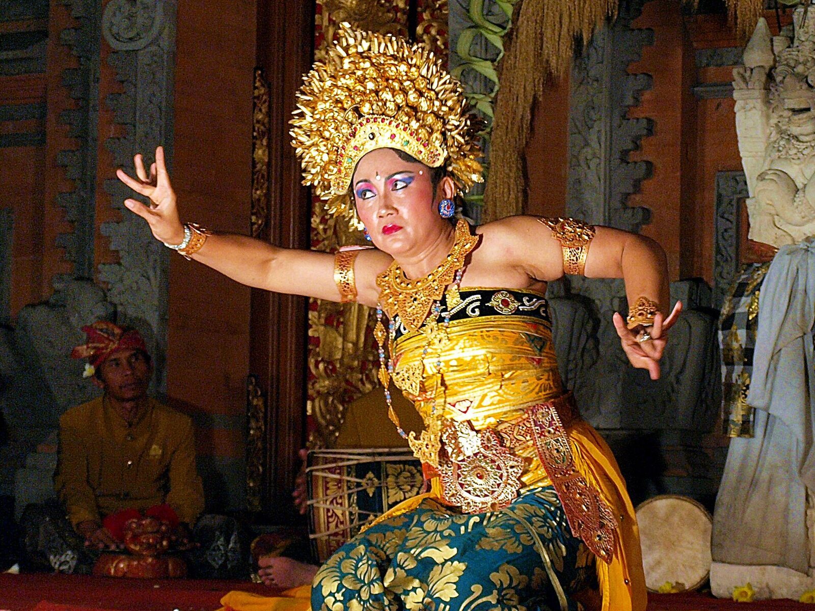 A Legong dancer in gold, live gamelan behind her — the least touristy-feeling 'tourist' thing in Ubud.
