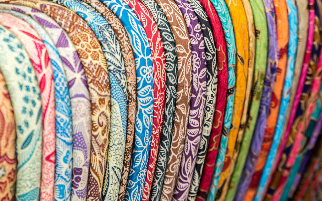 Stacked batik and sarongs — bring your haggling; the first price is for tourists.