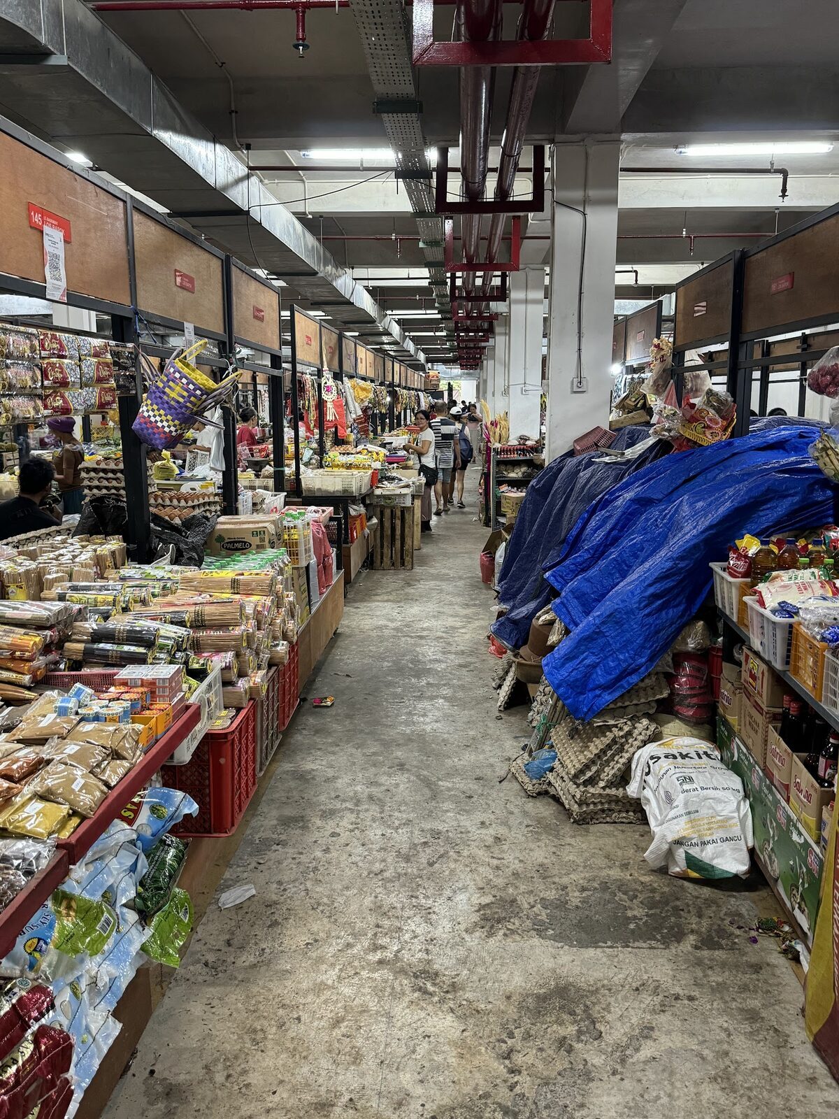 An aisle of the art market, goods stacked to the rafters.