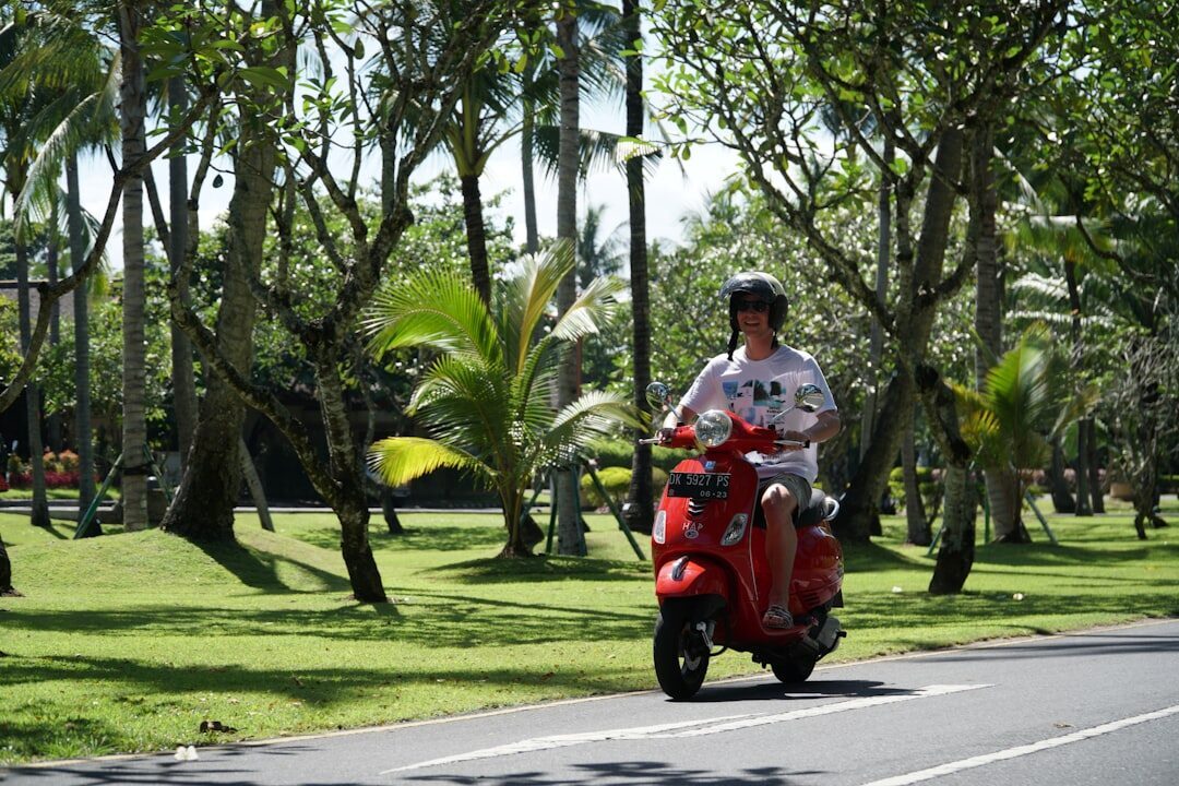 A scooter on a leafy road at the edge of the centre — quieter once you're out of the core.