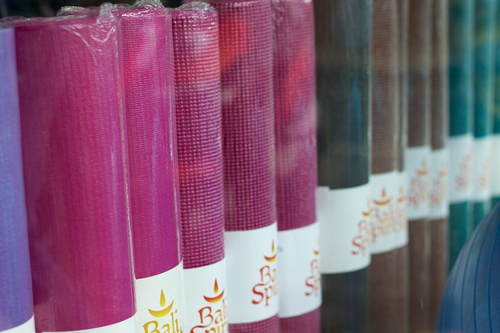 Yoga mats stacked for sale — the retreat economy runs deep here.