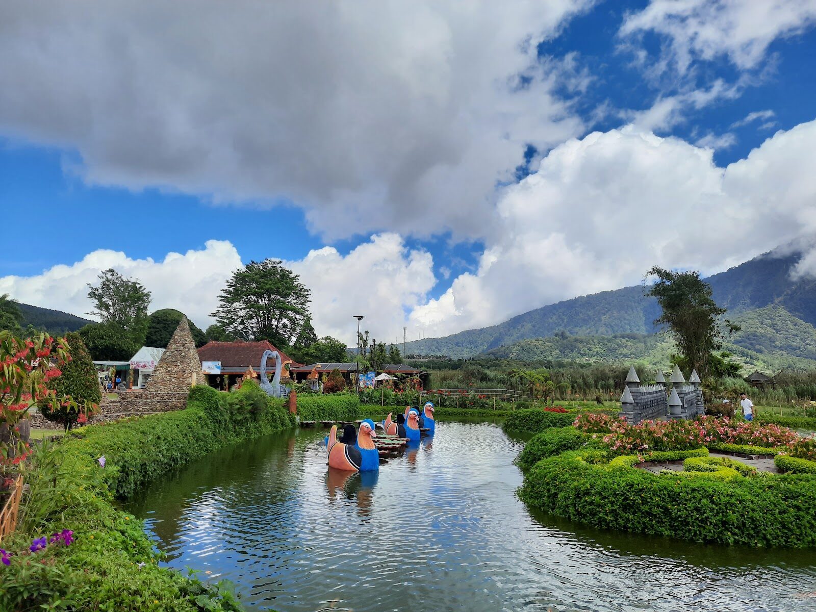 Visitors paddling the garden canal — the theme-park side of the grounds.