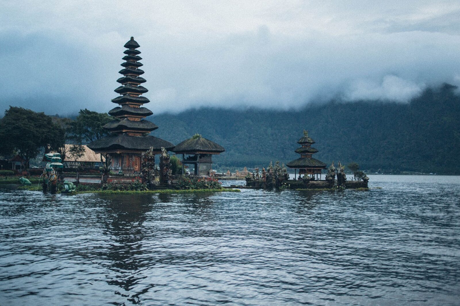 The meru reflected in dark, glassy water before the wind gets up.