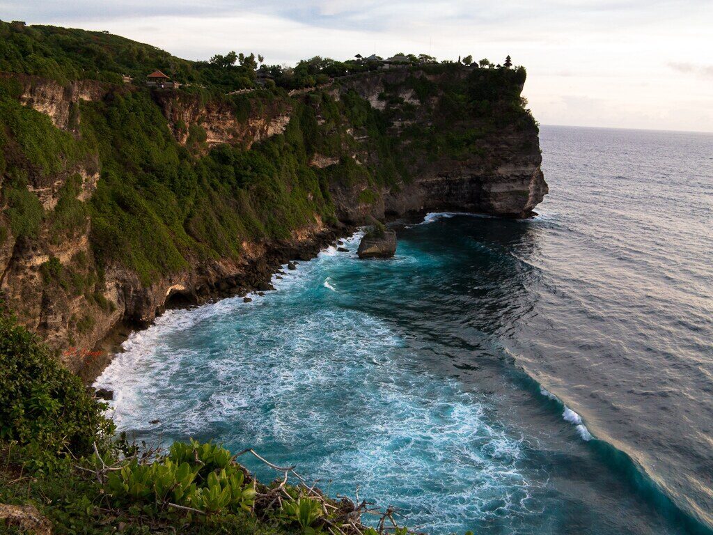 The headland and its surf under a moody sky.