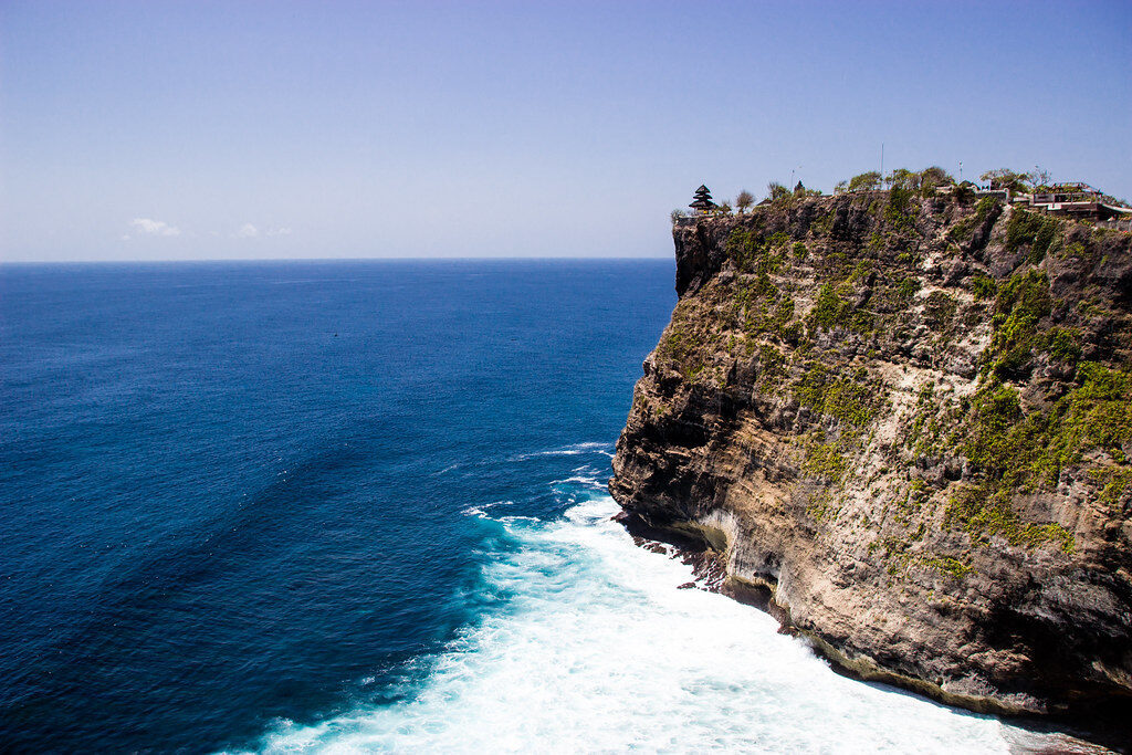 The headland dropping to the surf — the sea this temple is turned to face.